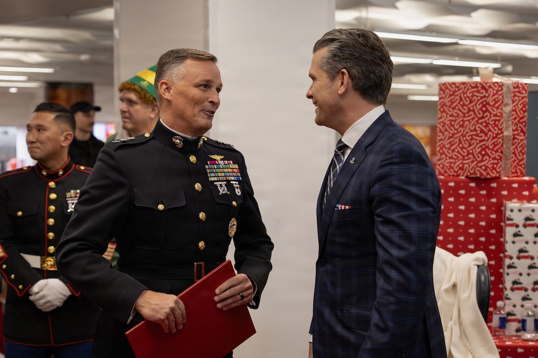U.S. Marine Corps Lt. Gen. Leonard F. Anderson IV, left, commander of Marine Forces Reserve and Marine Forces South, talks to the Secretary of War, Pete Hegseth, during a Toys for Tots charity drive and members of the U.S. Naval Academy at the Pentagon, Washington, D.C., Dec. 9, 2025. Since 1947, the Marine Corps Reserve has spearheaded the Toys for Tots program nationwide to collect toys for less fortunate children during the holiday season. Presently, the program distributes 7 to 18 million toys to children annually. (U.S. Marine Corps photo by Lance Cpl. Van Hoang)