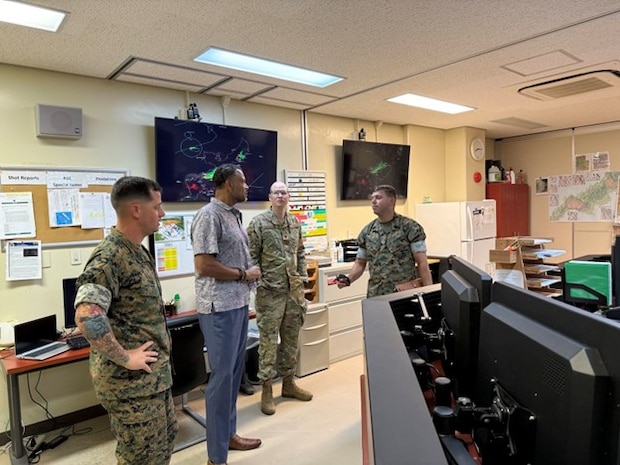 Camp Hansen Range Control personnel brief Pacific Multi Domain Training and Experimentation Capability Program Manager Dr. Andre Stridiron on PMTEC investments such as Land Mobile Network upgrades and UHF/VHF radios in their operations room, Camp Hansen, Okinawa, October 30, 2025.