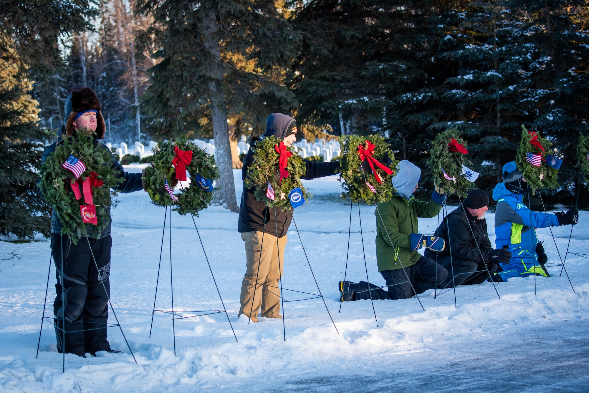 The ceremony opened with the presentation of wreaths honoring service members from every branch of the U.S. military. A member from each branch of service alongside a partner from the Alaska community carefully placed a wreath on display and rendered a salute in memory of their fallen brothers and sisters in arms. Following the presentation, approximately 400 volunteers including families, friends, service members and community members dispersed throughout the cemetery to place wreaths at gravesites, ensuring every hero was honored.