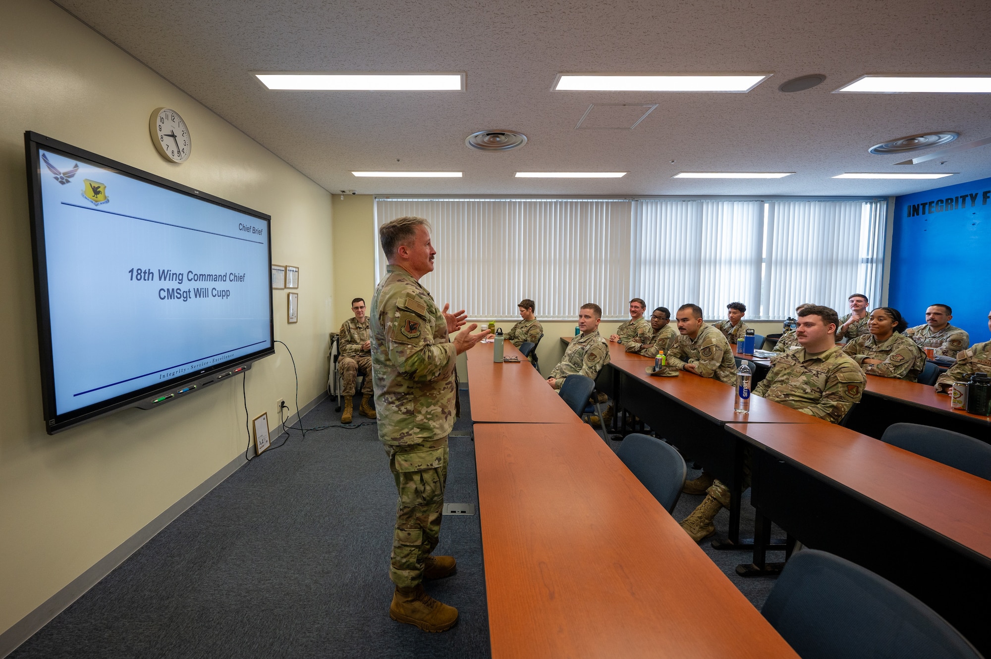 Service members listen to the speaker during the course.