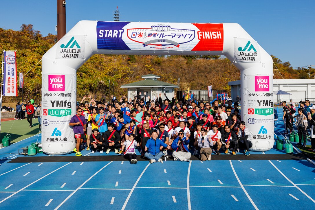 Participants pose for a group photo during the 2025 Iwakuni Friendship Relay Marathon at the Atago Sports Complex in Iwakuni, Japan, Dec. 7, 2025. The Iwakuni Friendship Relay Marathon helped build camaraderie through friendly competition, as well as winners receiving awards for being one of the top three teams in different categories, including primary school-aged, international, and best costume. (U.S. Marine Corps photo by Cpl. Dahkareo Pritchett)