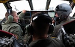 U.S. Navy Adm. Rich Correll (left), is shown the interior of a B-52H Stratofortress' cockpit by two 69th Bomb Squadron aircrew members.