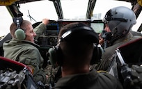 U.S. Navy Adm. Rich Correll (left), is shown the interior of a B-52H Stratofortress' cockpit by two 69th Bomb Squadron aircrew members.