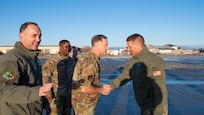 U.S. Navy Adm. Rich Correll (right) greets Team Minot leadership shortly after stepping off his aircraft.