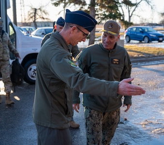 U.S. Air Force Col. Thomas Taylor (left) shows U.S. Navy Adm. Rich Correll into the 5th Bomb Wing headquarters building.