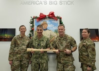 U.S. Strategic Command leadership and 91st Missile Wing leadership pose for a photo while holding a Bully Stick.
