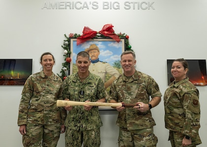 U.S. Strategic Command leadership and 91st Missile Wing leadership pose for a photo while holding a Bully Stick.