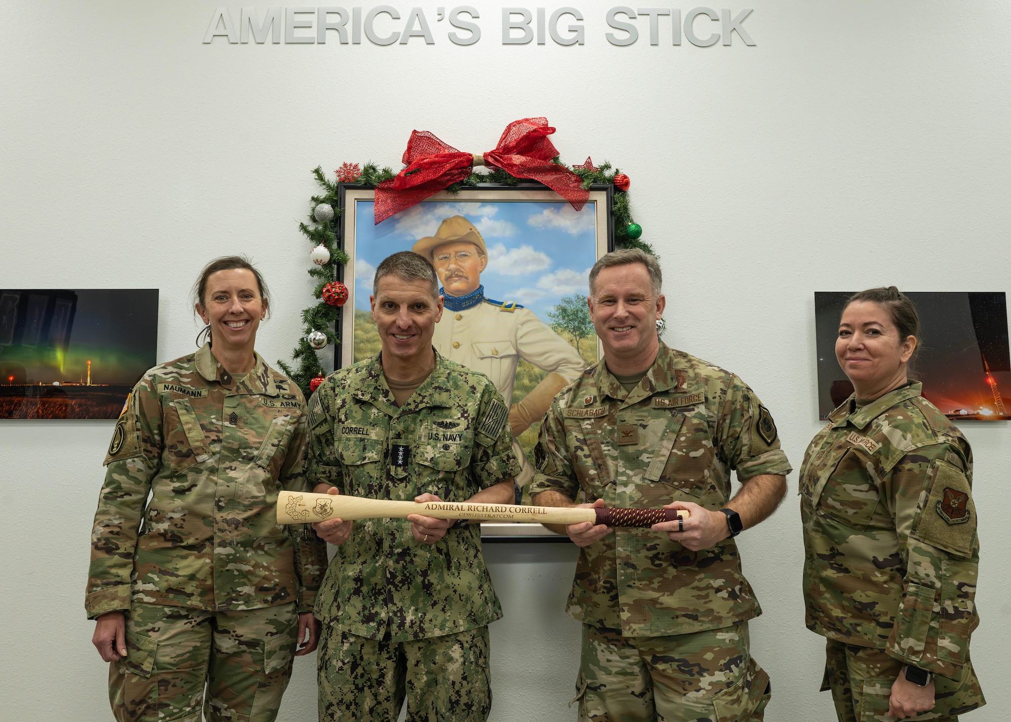 U.S. Strategic Command leadership and 91st Missile Wing leadership pose for a photo while holding a Bully Stick.
