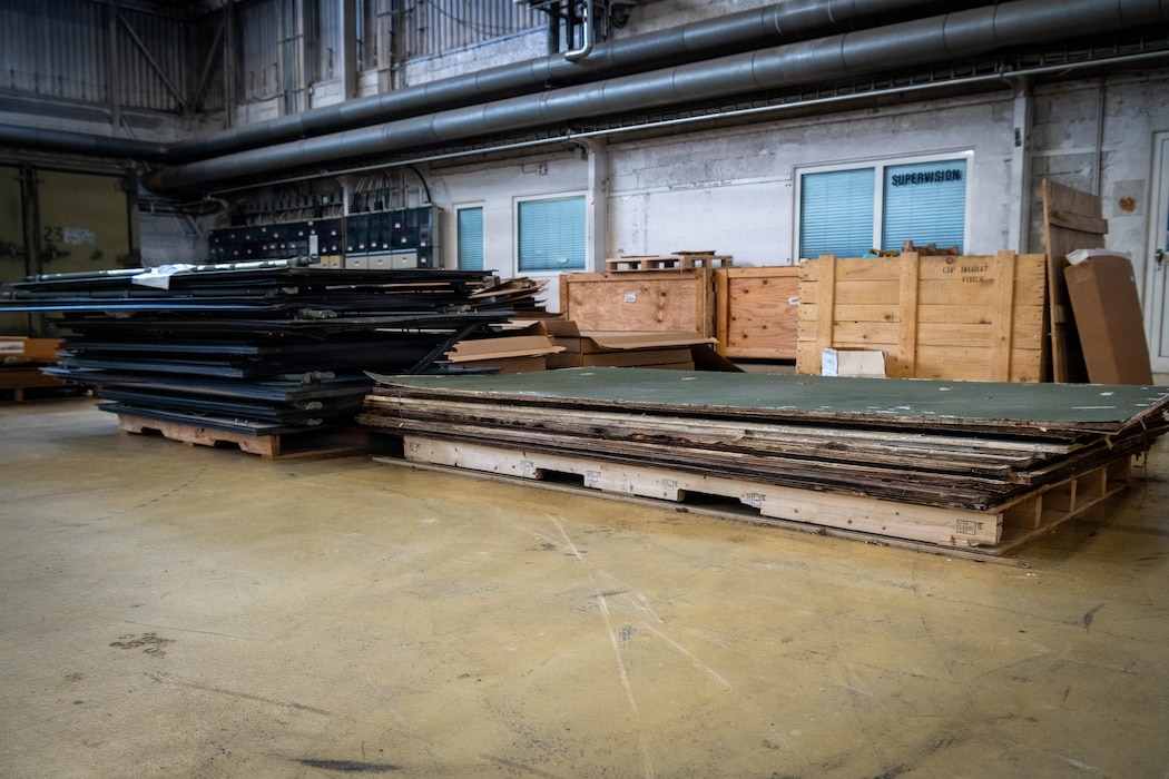 A pile of old doors lay on the ground.