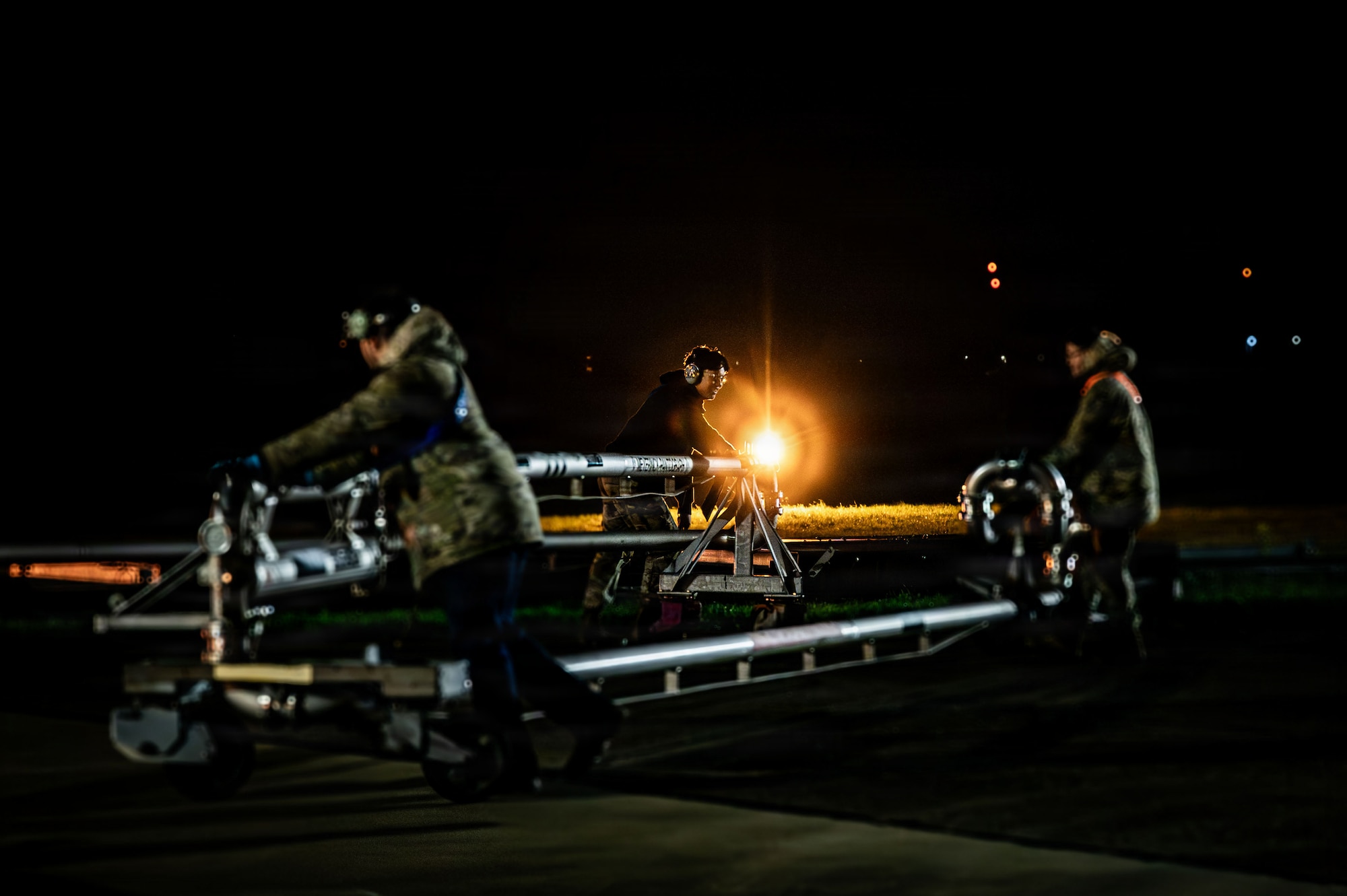 From left, U.S. Air Force Staff Sgt. Kevin Ferreira, 100th Aircraft Maintenance Squadron aerospace maintenance craftsman, Airman 1st Class Owen Willett, 100th AMXS crew chief, and Airman 1st Class Pahud- Hernandez, 100th Logistics Readiness Squadron fuels distribution operator, put away a KC-135 Stratotanker fuel pump at RAF Mildenhall, England, Nov. 19, 2025.