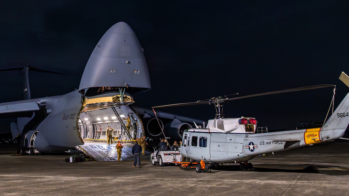 U.S. Air Force Airmen assigned to the 730th Air Mobility Squadron and the 22nd Airlift Squadron from Travis Air Force Base, Calif., load a UH-1N Huey into a C-5M Super Galaxy assigned to the 22nd AS at Yokota Air Base, Japan, Dec. 3, 2025. The UH-1N has supported Yokota AB operations since 1980, and its retirement aligns with the Air Force’s effort to modernize rotary-wing capabilities to meet today’s operational demands. (U.S. Air Force photo by Airman 1st Class David S. Calcote)