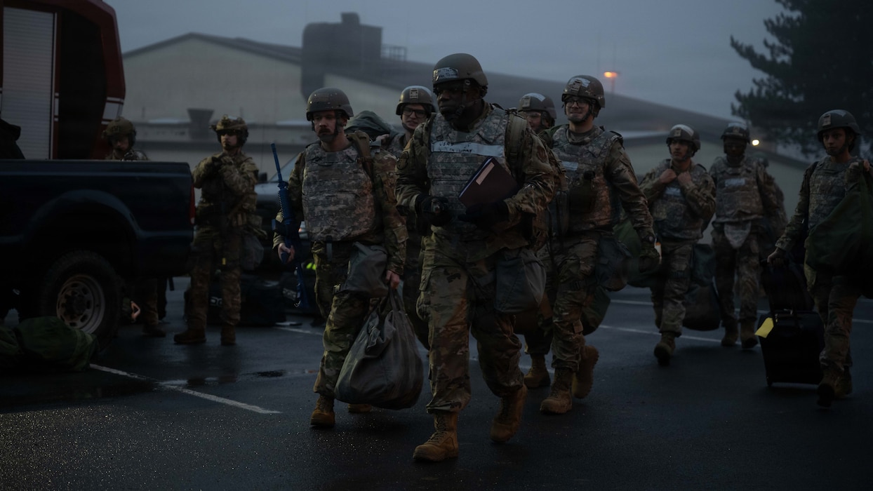 Airmen assigned to the 52nd Civil Engineer Squadron arrive at the training grounds during a beddown exercise at Spangdahlem Air Base, Germany, Dec. 5, 2025. This training allows CE Airmen to test their skills establishing a fortified operating location at any given moment. (U.S. Air Force photo by Senior Airman Darius Frazier)