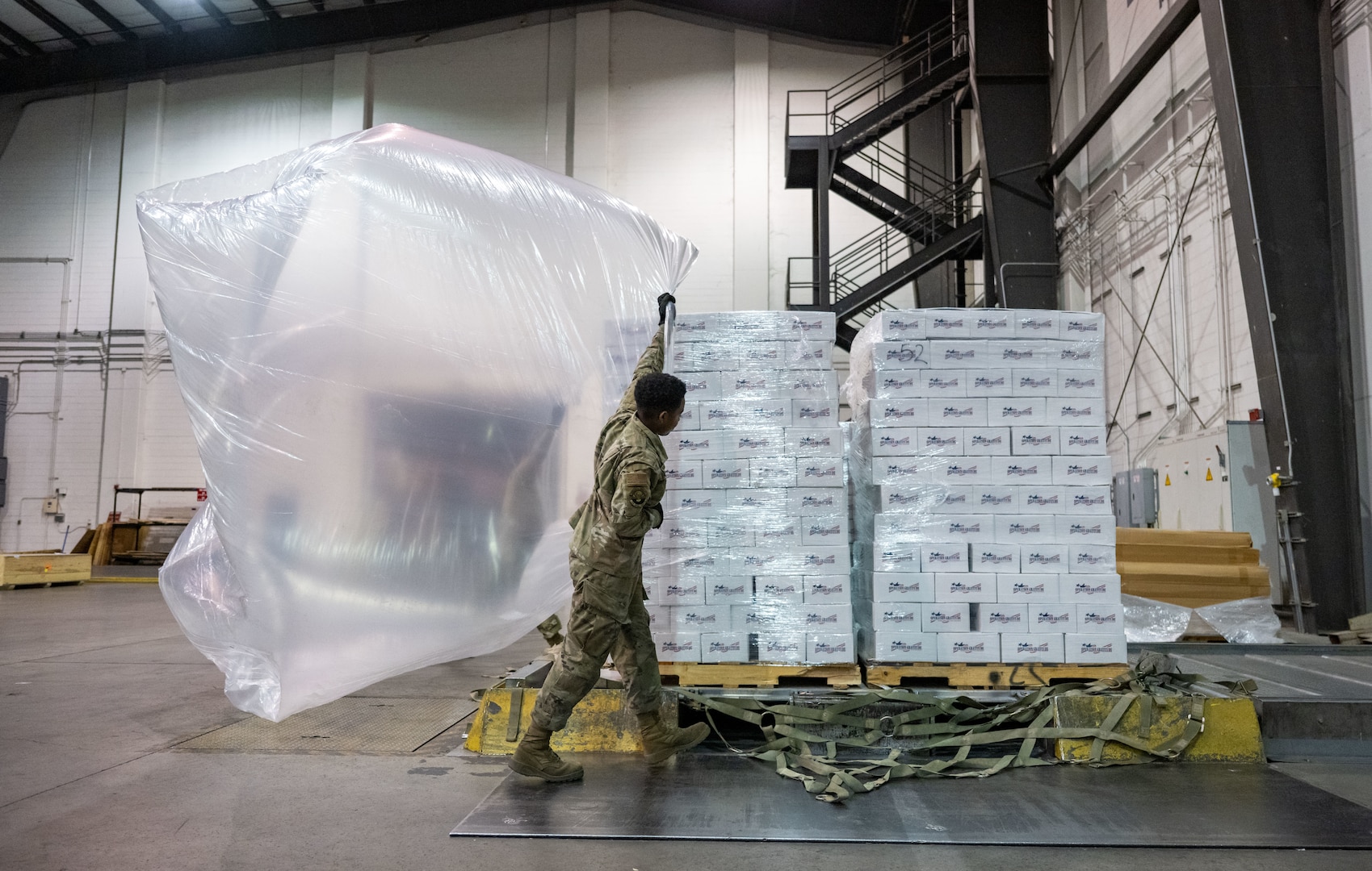 DOVER, DELAWARE (Nov. 26, 2025) A U.S. Airman prepares care packages to be delivered to troops in the Middle East at Dover Air Force Base, Delaware, Nov 26. Thousands of care packages will be distributed to service members operating from various locations, including Jordan, Syria, and Iraq. (U.S. Air Force photo by Senior Airman Amanda Jett)