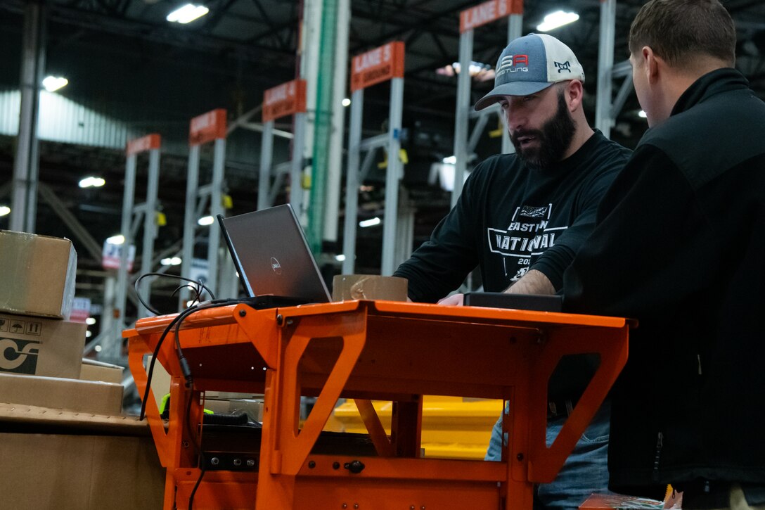 People in a warehouse learning how to use WMS.