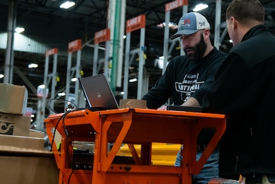 People in a warehouse learning how to use WMS.