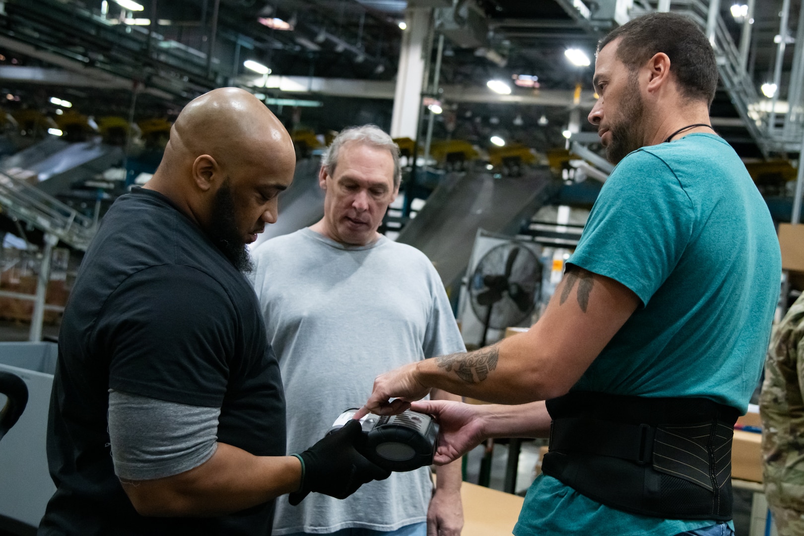 People in a warehouse learning how to use WMS.