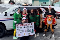 Members of the Fort Indiantown Gap police department and Fort Indiantown Gap Employees Association pose next to a police vehicle during the Cram-a-Cruiser campaign in Jonestown, Pennsylvania. More than 6,000 food items were collected that will be donated to area food banks to help those in need. (Courtesy photo)