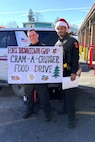 Fort Indiantown Gap police officers pose next to a police vehicle during the Cram-a-Cruiser campaign in Jonestown, Pennsylvania. More than 6,000 food items were collected that will be donated to area food banks to help those in need. (Courtesy photo)