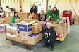 Members of the Fort Indiantown Gap police department and Fort Indiantown Gap Employees Association pose pose with some of the food that was collected during a food drive Dec. 9, 2025, at Fort Indiantown Gap, Pennsylvania. More than 6,000 food items were collected that will be donated to area food banks to help those in need. (Pennsylvania National Guard photo by Brad Rhen)