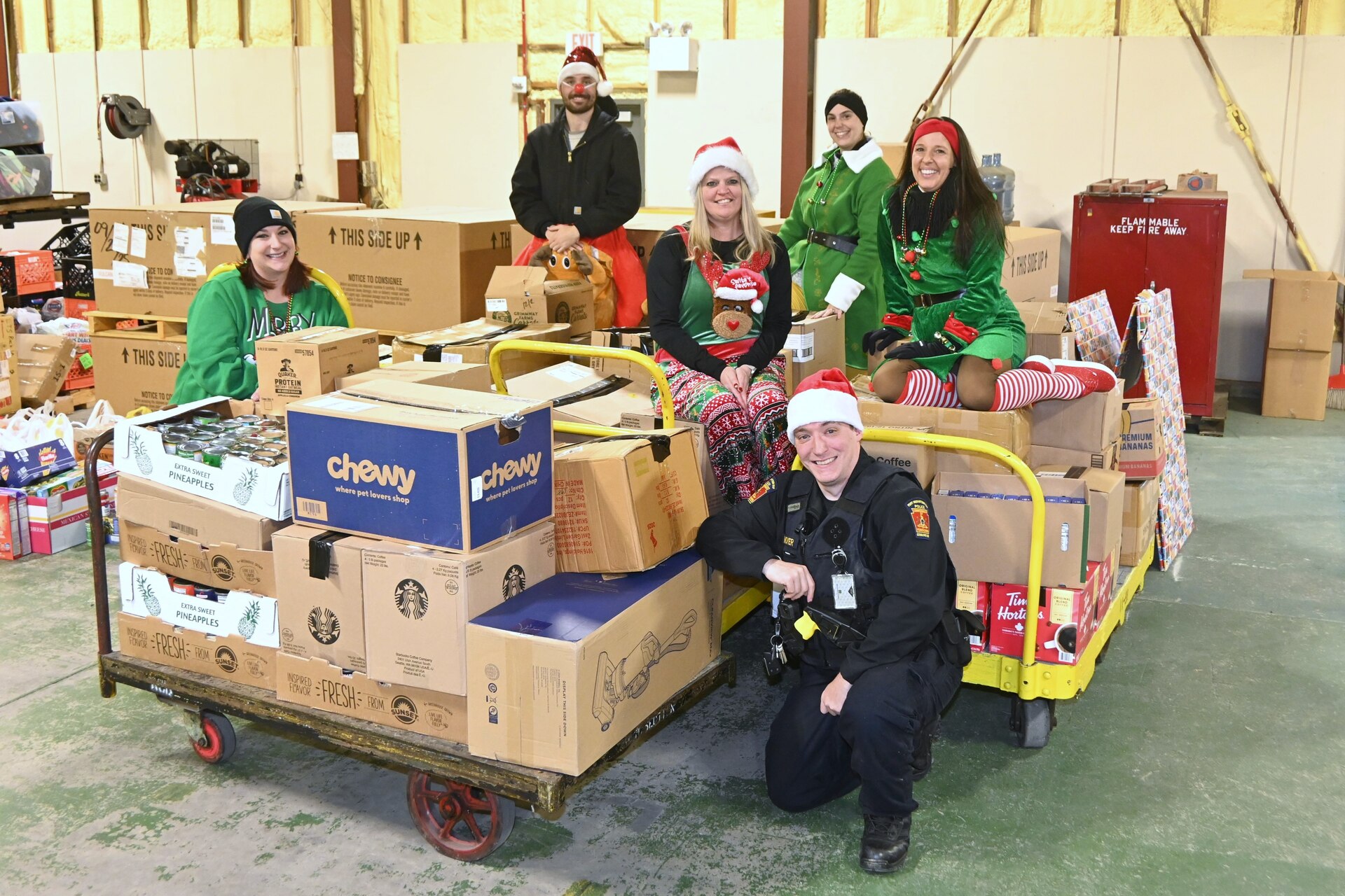 Members of the Fort Indiantown Gap police department and Fort Indiantown Gap Employees Association pose pose with some of the food that was collected during a food drive Dec. 9, 2025, at Fort Indiantown Gap, Pennsylvania. More than 6,000 food items were collected that will be donated to area food banks to help those in need. (Pennsylvania National Guard photo by Brad Rhen)