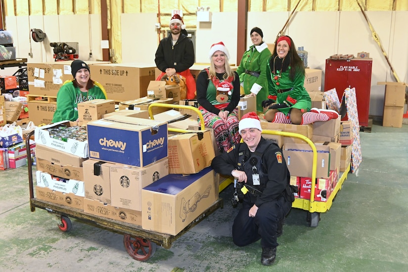 Members of the Fort Indiantown Gap police department and Fort Indiantown Gap Employees Association pose pose with some of the food that was collected during a food drive Dec. 9, 2025, at Fort Indiantown Gap, Pennsylvania. More than 6,000 food items were collected that will be donated to area food banks to help those in need. (Pennsylvania National Guard photo by Brad Rhen)