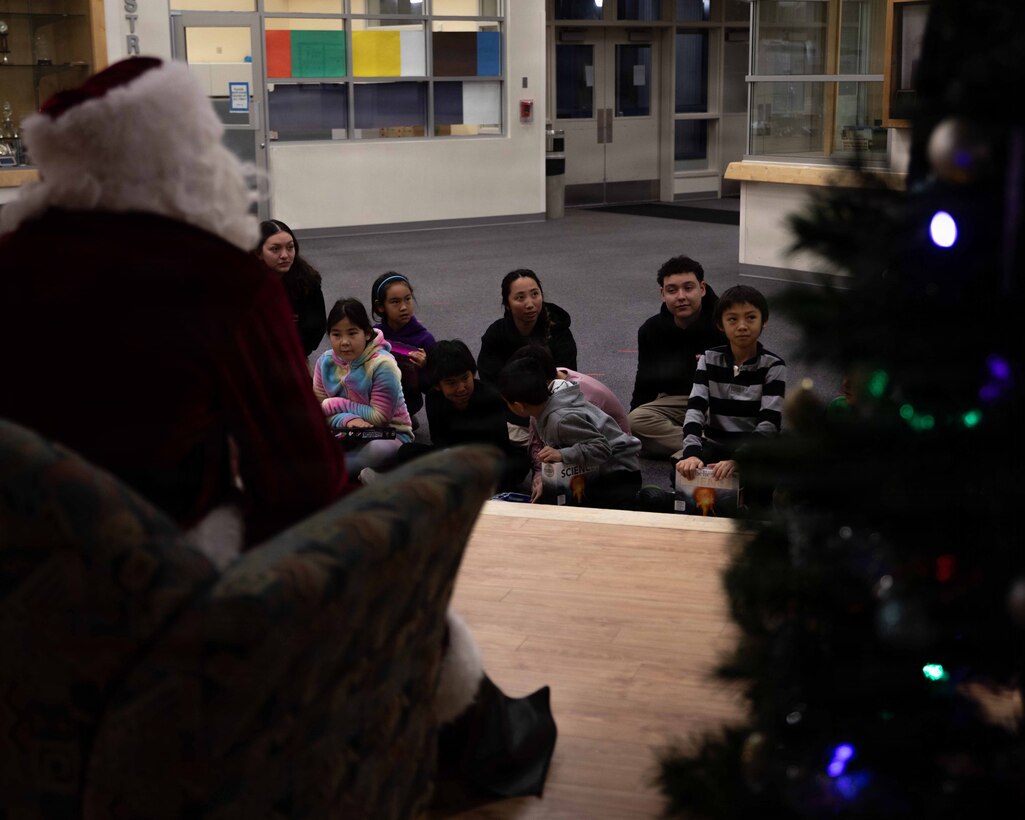 U.S. Marine Corps Capt. Daniel Kelly dressed as Santa Claus, greets a child attending June Nelson Elementary School in Kotzebue, Alaska, Dec. 8, 2025. Kelly, a military police officer and Inspector Instructor with 4th Law Enforcement Battalion, Force Headquarters Group delivered toys to the school with the assistance of Marines from Detachment Delta Company and U.S. Airmen from various units during this year’s Toys for Tots operation. The Toys for Tots mission exemplifies the Marine Corps spirit in the Last Frontier, strengthening community ties while sharpening the Marines' readiness for Arctic operations. (U.S. Marine Corps photo by Cpl. Orion Stpierre)