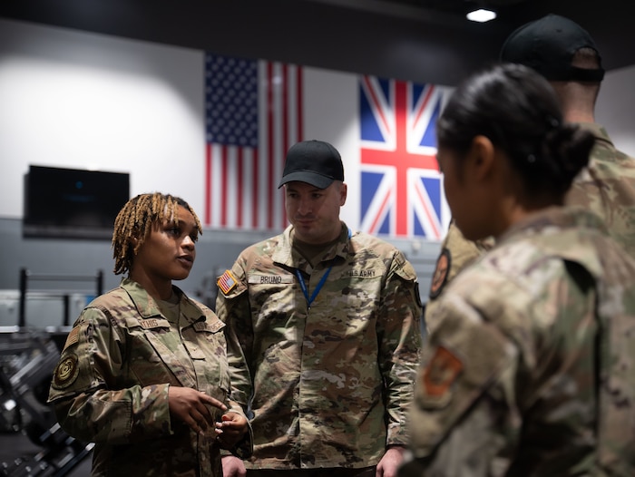 Military members listen to a brief.