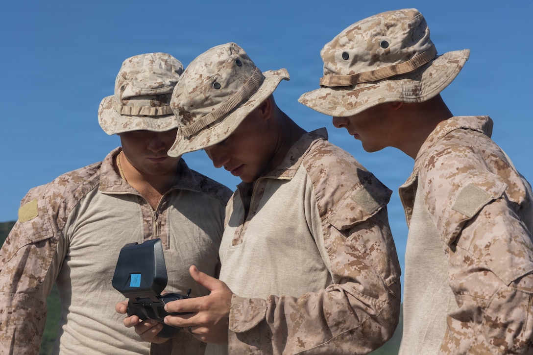 U.S. Marine Corps riflemen with Lima Company, Battalion Landing Team 3/6, 22nd Marine Expeditionary Unit (Special Operations Capable), monitor Skydio X2D small unmanned aircraft system footage during a seeking exercise on Camp Santiago, Puerto Rico, Dec. 14, 2025. U.S. military forces are deployed to the Caribbean in support of the U.S. Southern Command mission, Department of War-directed operations, and the president's priorities to disrupt illicit drug trafficking and protect the homeland. (U.S. Marine Corps photo)