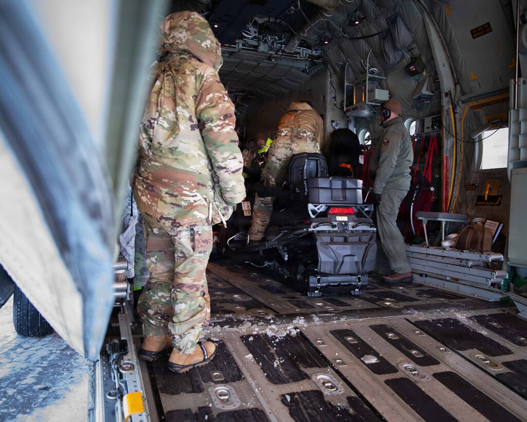 U.S. Marines and U.S. Airmen prepare to depart to town after arriving in Kotzebue, Alaska, Dec. 4, 2025. The Marines, assigned to Detachment Delta Company, 4th Law Enforcement Battalion, Force Headquarters Group and the Airmen, assigned to the 673rd Security Forces Squadron, are participating in Operation Polar Knight in support of the Toys for Tots mission reaching remote Alaskan communities. (U.S. Marine Corps photo by Cpl. Orion Stpierre)