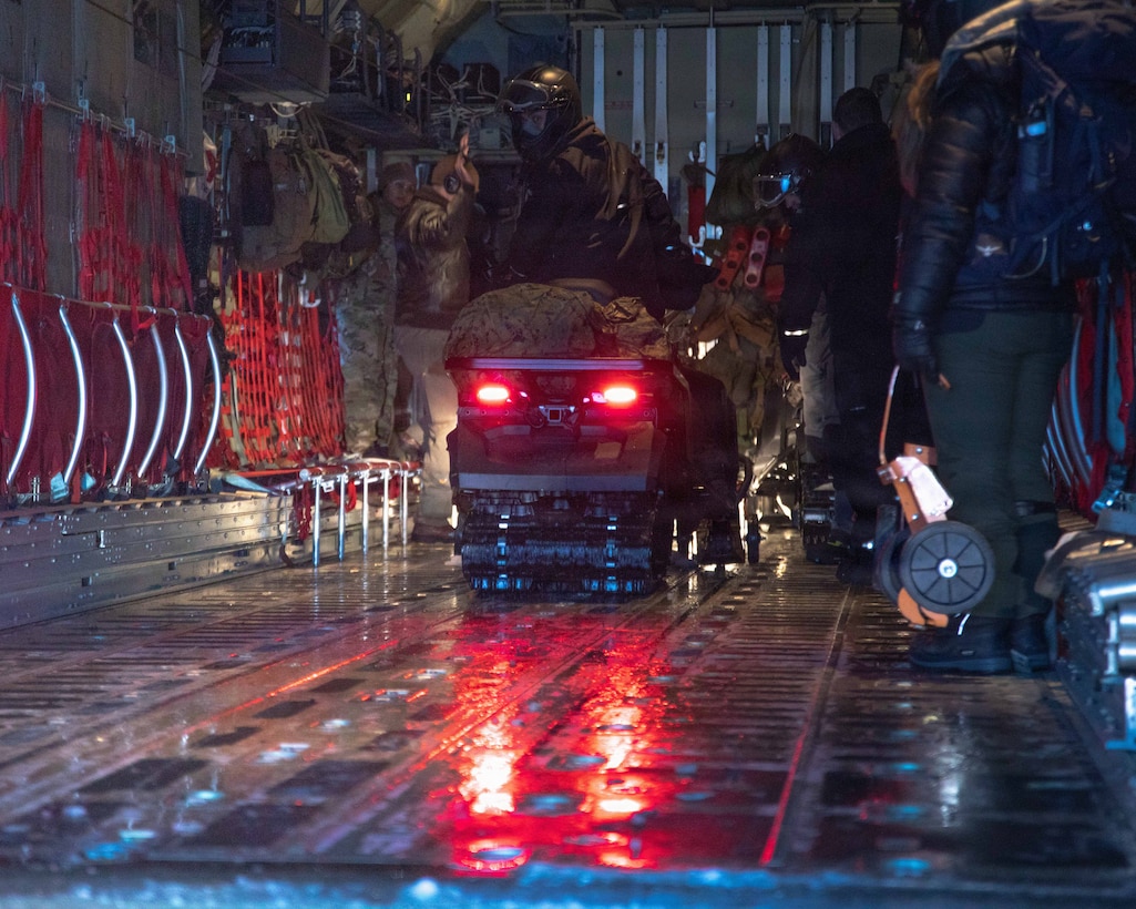 U.S. Marines and U.S. Airmen prepare to depart to town after arriving in Kotzebue, Alaska, Dec. 4, 2025. The Marines, assigned to Detachment Delta Company, 4th Law Enforcement Battalion, Force Headquarters Group and the Airmen, assigned to the 673rd Security Forces Squadron, are participating in Operation Polar Knight in support of the Toys for Tots mission reaching remote Alaskan communities. (U.S. Marine Corps photo by Cpl. Orion Stpierre)