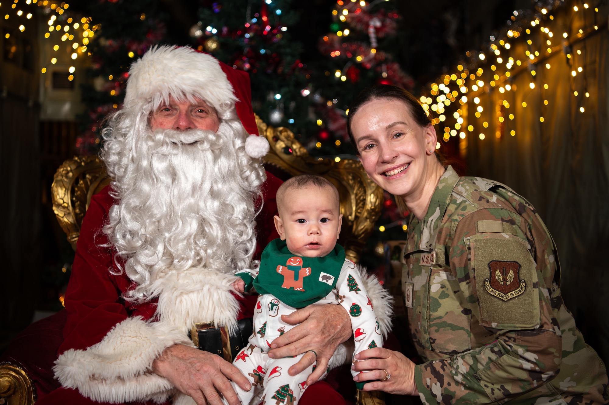 A photo of an Airman taking a photo with Santa