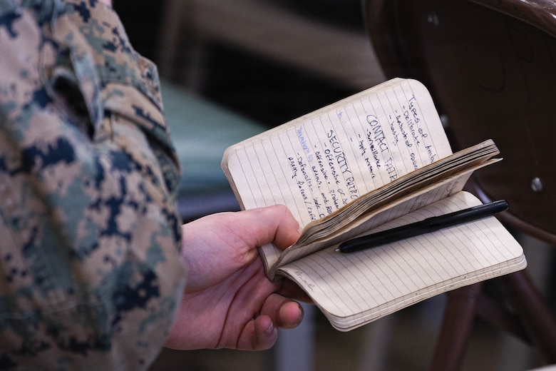 U.S. Marines with 25th Marine Regiment review their notes during the Yellow Ribbon Event at Fort Devens, Massachusetts, Dec. 13, 2025. The event provided resources, workshops and community-building opportunities to strengthen the resilience and readiness of military members and families before, during and after deployment. (U.S. Marine Corps photo by Lance Cpl. Priscilla Flores)