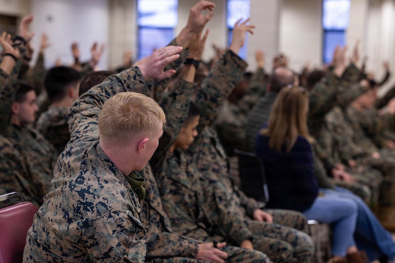 U.S. Marines with 25th Marine Regiment ask questions during the Yellow Ribbon Event at Fort Devens, Massachusetts, Dec. 13, 2025. The event provided resources, workshops and community-building opportunities to strengthen the resilience and readiness of military members and families before, during and after deployment. (U.S. Marine Corps photo by Lance Cpl. Priscilla Flores)