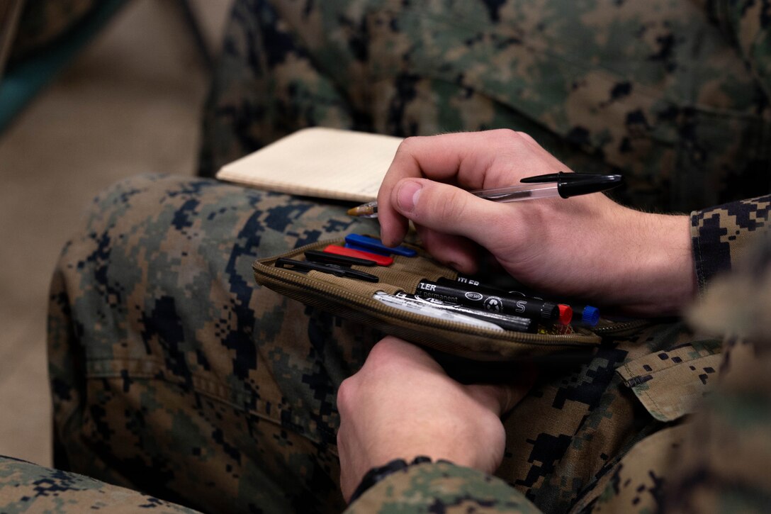 U.S. Marines with 25th Marine Regiment take notes during the Yellow Ribbon Event at Fort Devens, Massachusetts, Dec. 13, 2025. The event provided resources, workshops and community-building opportunities to strengthen the resilience and readiness of military members and families before, during and after deployment. (U.S. Marine Corps photo by Lance Cpl. Priscilla Flores)