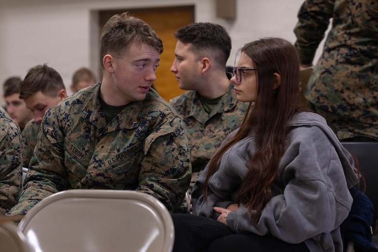 U.S. Marine Corps Lance Cpl. Noah Strom speaks with his wife, Linaya Strom, during the Yellow Ribbon Event at Fort Devens, Massachusetts, Dec. 13, 2025. Strom is a mortarman with Charlie Company, 1st Battalion, 25th Marine Regiment. The event provided resources, workshops and community-building opportunities to strengthen the resilience and readiness of military members and families before, during and after deployment. (U.S. Marine Corps photo by Lance Cpl. Priscilla Flores)
