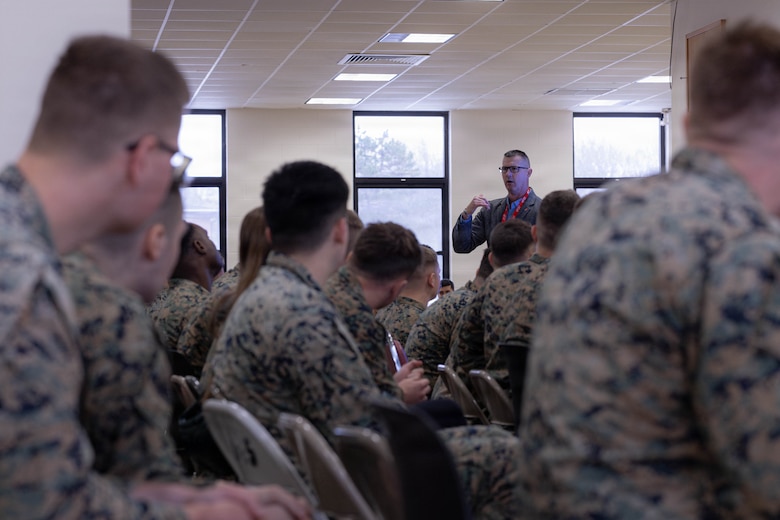 Tracy Linch, a guest speaker, briefs Marines with 25th Marine Regiment during the Yellow Ribbon Event at Fort Devens, Massachusetts, Dec. 13, 2025. The event provided resources, workshops and community-building opportunities to strengthen the resilience and readiness of military members and families before, during and after deployment. (U.S. Marine Corps photo by Lance Cpl. Priscilla Flores)