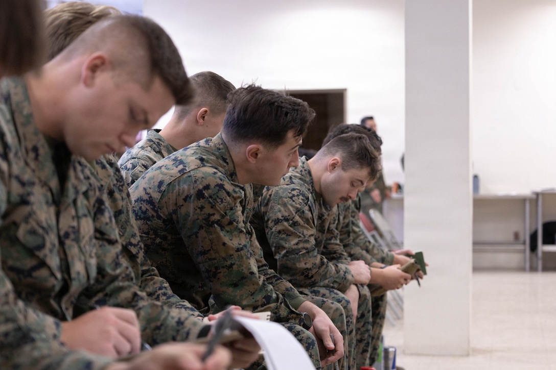 U.S. Marines with 25th Marine Regiment take notes during the Yellow Ribbon Event at Fort Devens, Massachusetts, Dec. 13, 2025. The event provided resources, workshops and community-building opportunities to strengthen the resilience and readiness of military members and families before, during and after deployment. (U.S. Marine Corps photo by Lance Cpl. Priscilla Flores)
