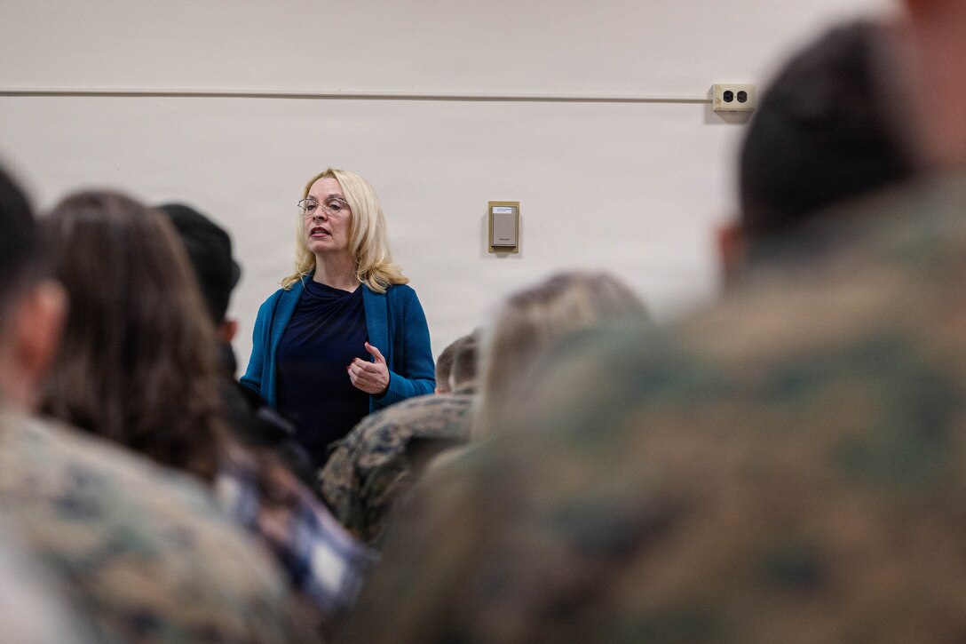 Michelle Nelson, deployment readiness coordinator, briefs Marines with 25th Marine Regiment and their families during the Yellow Ribbon Event at Fort Devens, Massachusetts, Dec. 13, 2025. The event provided resources, workshops and community-building opportunities to strengthen the resilience and readiness of military members and families before, during and after deployment. (U.S. Marine Corps photo by Lance Cpl. Priscilla Flores)