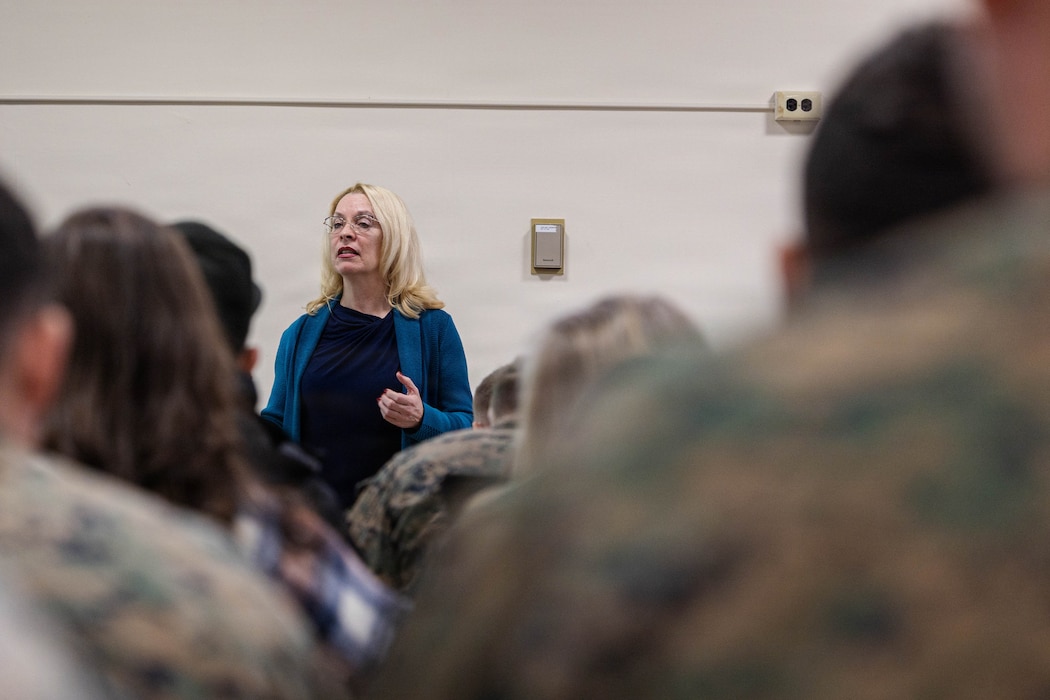 Michelle Nelson, deployment readiness coordinator, briefs Marines with 25th Marine Regiment and their families during the Yellow Ribbon Event at Fort Devens, Massachusetts, Dec. 13, 2025. The event provided resources, workshops and community-building opportunities to strengthen the resilience and readiness of military members and families before, during and after deployment. (U.S. Marine Corps photo by Lance Cpl. Priscilla Flores)
