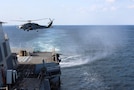 STRAIT OF HORMUZ (Dec. 15, 2025) An MH-60R Sea Hawk, assigned to Helicopter Maritime Strike Squadron (HSM) 79, departs from the flight deck of the Arleigh Burke-class guided-missile destroyer USS Roosevelt (DDG 80) during a Strait of Hormuz transit. Roosevelt is deployed to the U.S. 5th Fleet area of operations to support maritime security and stability in the U.S. Central Command area of responsibility. (U.S. Navy photo by Mass Communication Specialist 1st Class Indra Beaufort)