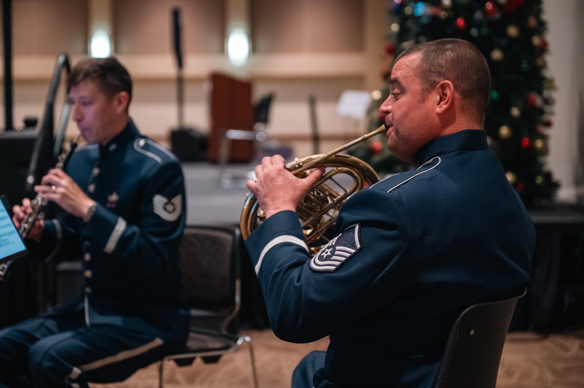 two men play instruments for a band