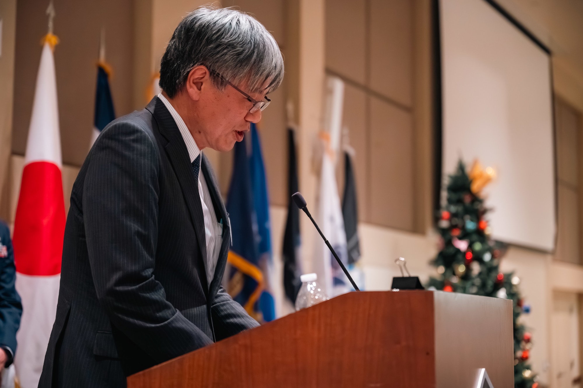 man stands at podium
