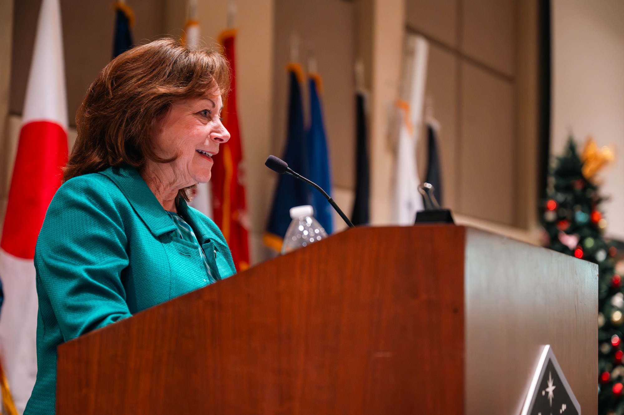 woman stands at podium