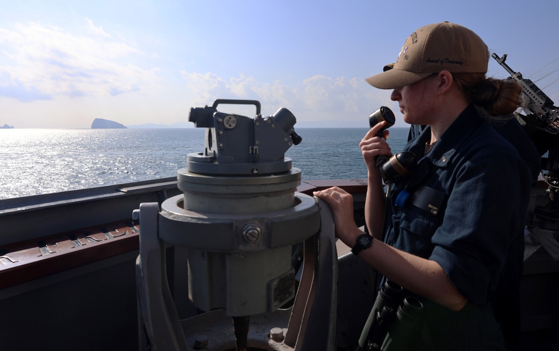 STRAIT OF HORMUZ (Dec. 15, 2025) U.S. Navy Ensign Madeline Brown, assigned to the Arleigh Burke-class guided-missile destroyer USS Roosevelt (DDG 80), communicates to the pilothouse as conning officer during a Strait of Hormuz transit. Roosevelt is deployed to the U.S. 5th Fleet area of operations to support maritime security and stability in the U.S. Central Command area of responsibility. (U.S. Navy photo by Mass Communication Specialist 1st Class Indra Beaufort)