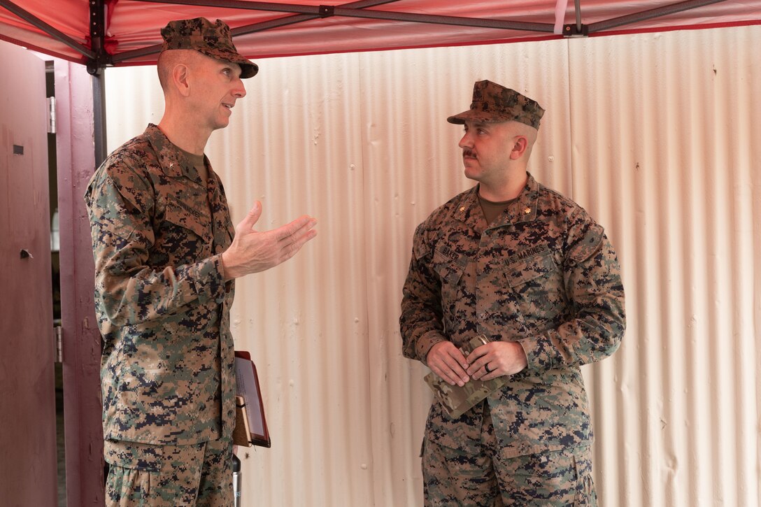 Brig. Gen. David Winnacker, left, speaks with Maj. Nicholas Baker during an Individual Ready Reserve (IRR) muster at Camp Pendleton, California, Dec. 14, 2025. Baker is an operations and planning officer, and Winnacker is the commanding general of Force Headquarters Group, Marine Forces Reserve. During these muster events, Marine Corps Individual Reserve Support Activity (MCIRSA) conducts an administrative screening of IRR Marines to ensure their readiness to augment and reinforce the active component. (U.S. Marine Corps photo by Sgt. Emily De La Torre)