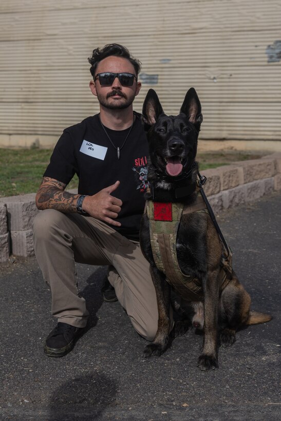 Cpl. Tyler Reed poses for a photo with his dog Doden during an Individual Ready Reserve (IRR) Muster at Camp Pendleton, California, Dec. 14, 2025. Reed is a Marine in the IRR. During these muster events, Marine Corps Individual Reserve Support Activity (MCIRSA) conducts an administrative screening of IRR Marines to ensure their readiness to augment and reinforce the active component. (U.S. Marine Corps photo by Sgt. Emily De La Torre)