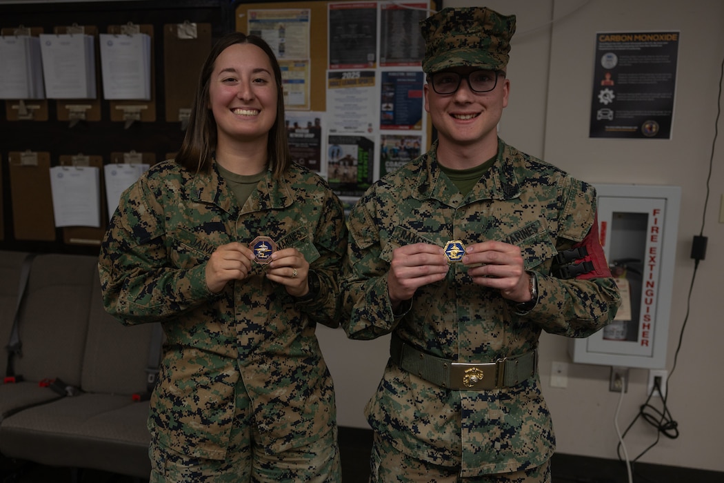 Lance Cpl. Lani Jaimes, left, and Sgt. Kristaphor Rakestraw pose with coins given to them by Brig. Gen. David Winnacker, the commanding general of Force Headquarters Group, Marine Forces Reserve during an Individual Ready Reserve (IRR) Muster at Camp Pendleton, California, Dec. 14, 2025. Jaimes is an administrative specialist and Rakestraw is a ground electronics transmission systems maintainer with Deployment Processing Command/Reserve Support Unit- West. During these muster events, Marine Corps Individual Reserve Support Activity (MCIRSA) conducts an administrative screening of IRR Marines to ensure their readiness to augment and reinforce the active component. (U.S. Marine Corps photo by Sgt. Emily De La Torre)
