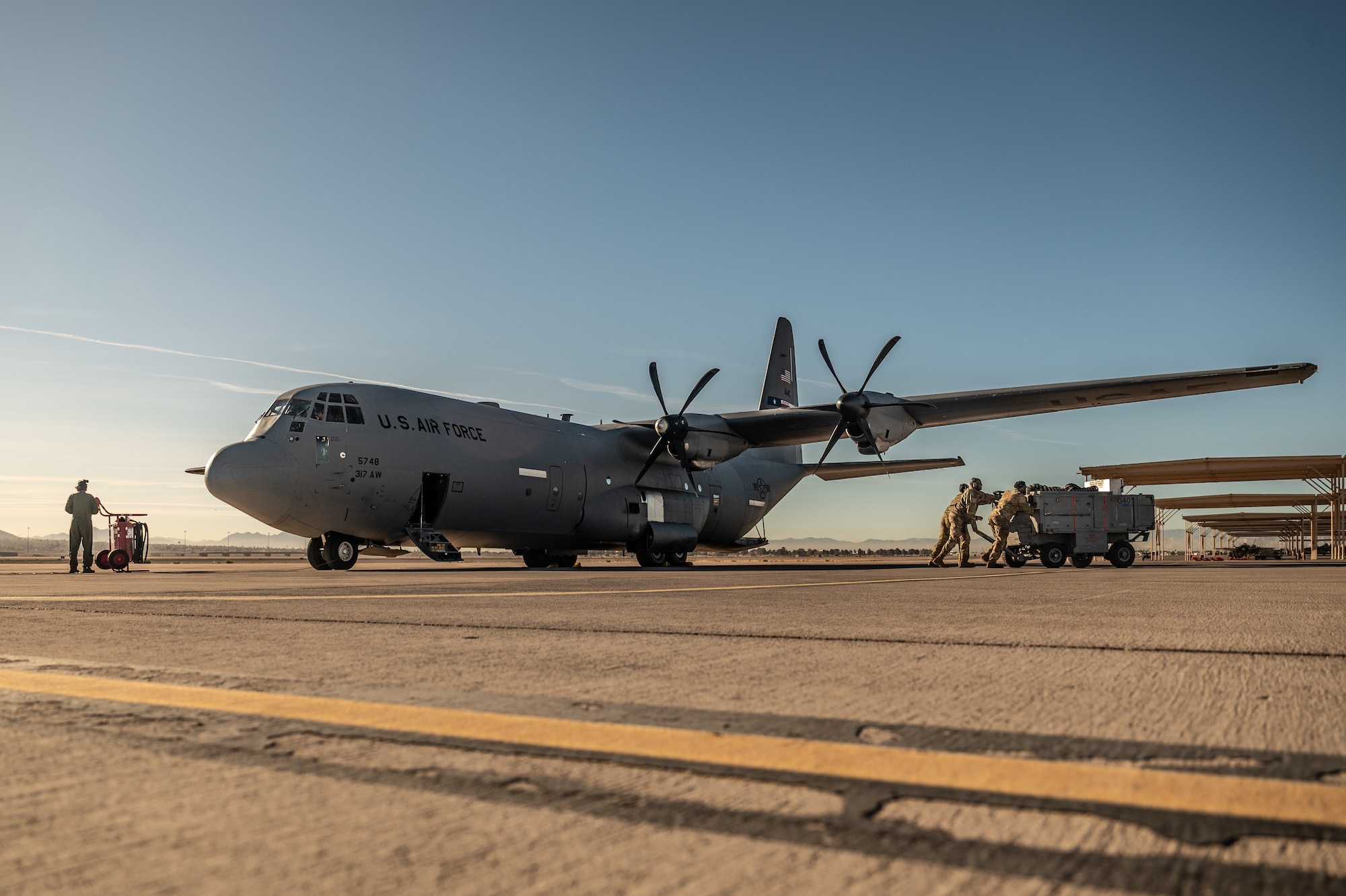 a person stands in front of an aircraft