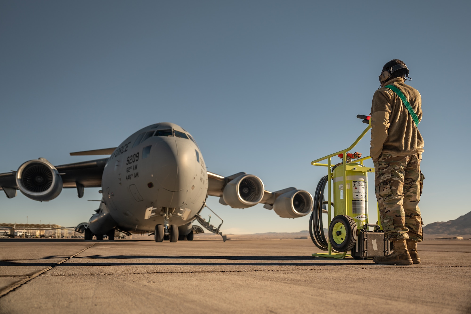 a person stands in front of an aircraft