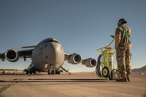 a person stands in front of an aircraft